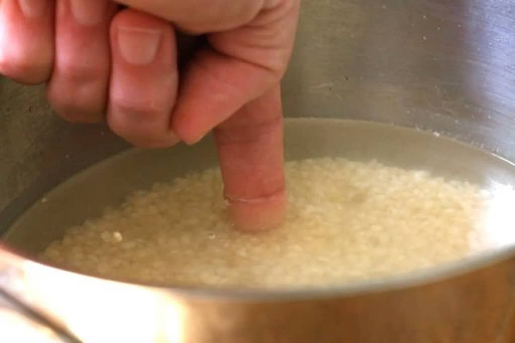 Finger Method: Measuring water in rice cooker.